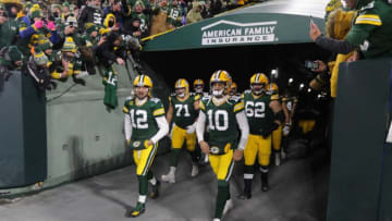Green Bay Packers quarterback Aaron Rodgers (12), quarterback Jordan Love (10) and teammates head to the field to warm up before the Green Bay Packers divisional playoff game' against the San Francisco 49ers at Lambeau Field in Green Bay on Saturday, Jan. 22, 2022.Packers 2600