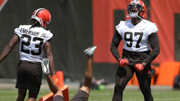 Cleveland Browns defensive tackle Perrion Winfrey, right, celebrates after cornerback Martin Emerson Jr. knocked over a member of the coaching staff in drills during the NFL football team's rookie minicamp in Berea on Friday.Browns 2