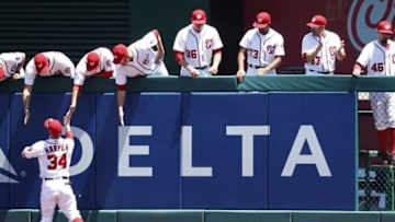 Jul 17, 2016; Washington, DC, USA; Washington Nationals right fielder Bryce Harper (34) high-fives teammates in the bullpen prior to the Nationals