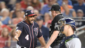 WASHINGTON, DC - AUGUST 31: Manager Dave Martinez #4 of the Washington Nationals argues a call with umpire Chad Whitson in the sixth inning during a baseball game against the Milwaukee Brewers at Nationals Park on August 31, 2018 in Washington, DC. (Photo by Mitchell Layton/Getty Images)