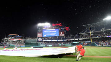 WASHINGTON, DC - SEPTEMBER 7: The grounds crew pulls the tarp onto the field during a rain delay of the Washington Nationals and Chicago Cubs game at Nationals Park on September 7, 2018 in Washington, DC. (Photo by Rob Carr/Getty Images)