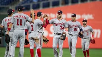 PHILADELPHIA, PA - SEPTEMBER 12: Ryan Zimmerman #11, Anthony Rendon #6, Wilmer Difo #1, Trea Turner #7, Bryce Harper #34, Juan Soto #22, and Adam Eaton #2 of the Washington Nationals high five one another after defeating the Philadelphia Phillies at Citizens Bank Park on September 12, 2018 in Philadelphia, Pennsylvania. The Nationals defeated the Phillies 5-1. (Photo by Mitchell Leff/Getty Images)