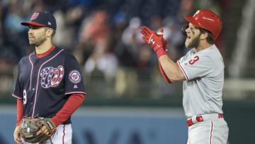 WASHINGTON, DC - APRIL 02: Bryce Harper #3 of the Philadelphia Phillies celebrates in front of Brian Dozier #9 of the Washington Nationals after hitting an RBI single during the sixth inning at Nationals Park on April 2, 2019 in Washington, DC. (Photo by Scott Taetsch/Getty Images)