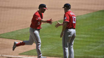 MIAMI, FL - APRIL 21: Brian Dozier #9 of the Washington Nationals is congratulated by Third Base Coach Bob Henley #13 after hitting a home run in the fourth inning against the Miami Marlins at Marlins Park on April 21, 2019 in Miami, Florida. (Photo by Eric Espada/Getty Images)