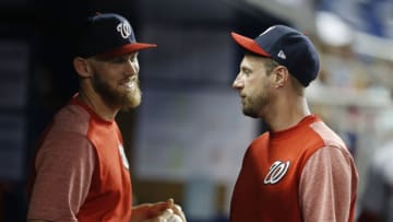 Max Scherzer #31 of the Washington Nationals talks with Stephen Strasburg #37 in the dugout against the Miami Marlins at Marlins Park on April 19, 2019 in Miami, Florida. (Photo by Michael Reaves/Getty Images)