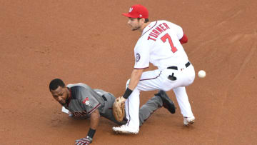 WASHINGTON, DC - JUNE 13: Jarrod Dyson #1 of the Arizona Diamondbacks slides safety past Trea Turner #7 of the Washington Nationals for a lead off double in the first inning during a baseball game at Nationals Park on June 13, 2019 in Washington, DC. (Photo by Mitchell Layton/Getty Images)