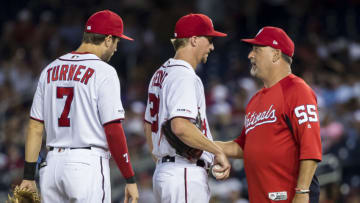 Pitching coach Paul Menhart #55 of the Washington Nationals speaks with Erick Fedde #23 during the third inning against the Philadelphia Phillies at Nationals Park on June 20, 2019 in Washington, DC. (Photo by Scott Taetsch/Getty Images)