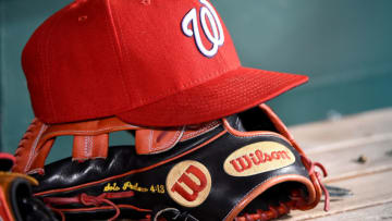 WASHINGTON, DC - SEPTEMBER 25: A general view of a Washington Nationals baseball hat on top of a Wilson baseball glove during the game against the Philadelphia Phillies at Nationals Park on September 25, 2019 in Washington, DC. (Photo by Will Newton/Getty Images)