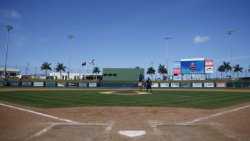 Grounds crew workers clean up the field after the Grapefruit League spring training game between the Washington Nationals and the New York Yankees at FITTEAM Ballpark of The Palm Beaches on March 12, 2020 in West Palm Beach, Florida. The MLB suspended the remaining spring training games due to the ongoing threat of the Coronavirus (COVID-19) outbreak. (Photo by Michael Reaves/Getty Images)