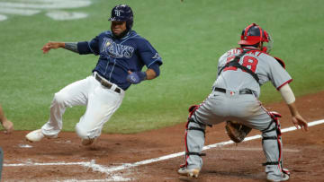 Manuel Margot #13 of the Tampa Bay Rays slides in safely to score as Kurt Suzuki #28 of the Washington Nationals awaits a late throw in the fifth inning of a baseball game at Tropicana Field on September 15, 2020 in St. Petersburg, Florida. (Photo by Mike Carlson/Getty Images)