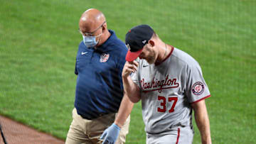 Stephen Strasburg #37 of the Washington Nationals walks off the field with trainer Paul Lessard after coming out of the game in the first inning against the Baltimore Orioles at Oriole Park at Camden Yards on August 14, 2020 in Baltimore, Maryland. (Photo by G Fiume/Getty Images)