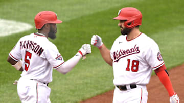 Josh Harrison #5 of the Washington Nationals celebrates scoring a run with Jake Noll #18 during a baseball game against the New York Mets at Nationals Park on September 27, 2020 in Washington, DC. (Photo by Mitchell Layton/Getty Images)