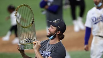 ARLINGTON, TEXAS - OCTOBER 27: Clayton Kershaw #22 of the Los Angeles Dodgers celebrates with the Commissioners Trophy after defeating the Tampa Bay Rays 3-1 in Game Six to win the 2020 MLB World Series at Globe Life Field on October 27, 2020 in Arlington, Texas. (Photo by Tom Pennington/Getty Images)
