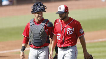 Yan Gomes #10 of the Washington Nationals talks with Brad Hand #52 against the Miami Marlins during the seventh inning of a Grapefruit League spring training game at Roger Dean Chevrolet Stadium on March 11, 2021 in Jupiter, Florida. (Photo by Michael Reaves/Getty Images)