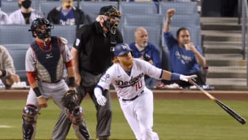 Justin Turner #10 of the Los Angeles Dodgers reacts to his RBI double in front of Yan Gomes #10 of the Washington Nationals, to take a 6-1 lead, during the fifth inning at Dodger Stadium on April 10, 2021 in Los Angeles, California. (Photo by Harry How/Getty Images)