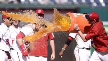 Carter Kieboom #8 of the Washington Nationals is doused with gatorade by Erick Fedde #23 after driving in the game winning run with a single in the ninth inning against the New York Mets at Nationals Park on September 06, 2021 in Washington, DC. (Photo by Greg Fiume/Getty Images)