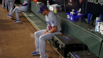 Max Scherzer #31 of the Los Angeles Dodgers sits in the dugout prior to Game Two of the National League Championship Series against the Atlanta Braves at Truist Park on October 17, 2021 in Atlanta, Georgia. (Photo by Kevin C. Cox/Getty Images)