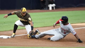 SAN DIEGO, CA - AUGUST 18: Michael Taylor #3 of the Washington Nationals is tagged out by Yangervis Solarte #26 of the San Diego Padres as he slides into third base during the second inning of a baseball game at PETCO Park on August 18, 2017 in San Diego, California. (Photo by Denis Poroy/Getty Images)