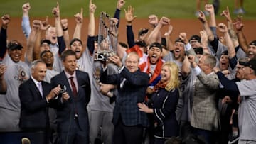 LOS ANGELES, CA - NOVEMBER 01: Houston Astros owner and chairman Jim Crane hoists the Commissioner's Trophy after the Astros defeated the Los Angeles Dodgers 5-1 in game seven to win the 2017 World Series at Dodger Stadium on November 1, 2017 in Los Angeles, California. (Photo by Kevork Djansezian/Getty Images)