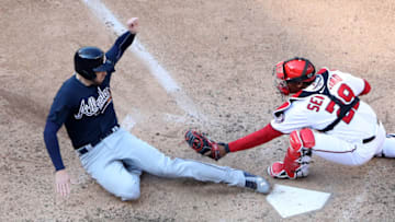 WASHINGTON, DC - APRIL 11: Freddie Freeman #5 of the Atlanta Braves slides in safely to score ahead of the tag by catcher Pedro Severino #29 of the Washington Nationals in the twelfth inning of the Braves 5-3 win at Nationals Park on April 11, 2018 in Washington, DC. (Photo by Rob Carr/Getty Images)