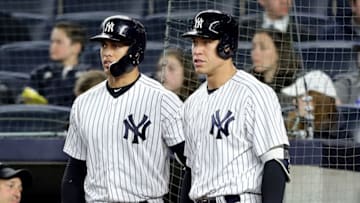 NEW YORK, NY - APRIL 16: Giancarlo Stanton #27 and Aaron Judge #99 of the New York Yankees talk during a pitchig change by the Miami Marlins in the sixth inning at Yankee Stadium on April 16, 2018 in the Bronx borough of New York City. (Photo by Elsa/Getty Images)