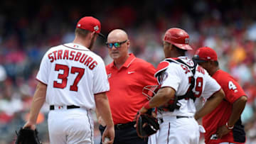 WASHINGTON, DC - MAY 20: Starting pitcher Stephen Strasburg #37 of the Washington Nationals talks with athletic trainer Paul Lessard in the third inning against the Los Angeles Dodgers at Nationals Park on May 20, 2018 in Washington, DC. (Photo by Patrick McDermott/Getty Images)