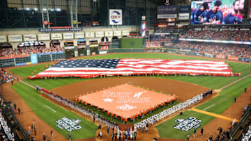 HOUSTON, TEXAS - OCTOBER 22: An American flag is displayed as singer-songwriter Nicole Scherzinger performs the national anthem prior to Game One of the 2019 World Series between the Houston Astros and the Washington Nationals at Minute Maid Park on October 22, 2019 in Houston, Texas. (Photo by Bob Levey/Getty Images)