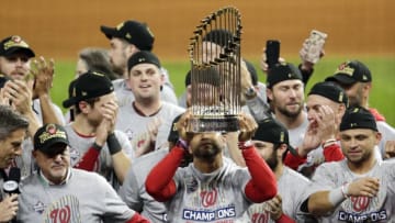 HOUSTON, TEXAS - OCTOBER 30: Manager Dave Martinez #4 of the Washington Nationals hoists the Commissioners Trophy after defeating the Houston Astros 6-2 in Game Seven to win the 2019 World Series in Game Seven of the 2019 World Series at Minute Maid Park on October 30, 2019 in Houston, Texas. (Photo by Bob Levey/Getty Images)