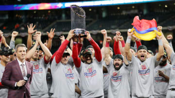 HOUSTON, TEXAS - OCTOBER 30: Manager Dave Martinez #4 of the Washington Nationals hoists the Commissioners Trophy after defeating the Houston Astros 6-2 in Game Seven to win the 2019 World Series in Game Seven of the 2019 World Series at Minute Maid Park on October 30, 2019 in Houston, Texas. (Photo by Elsa/Getty Images)