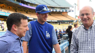 LOS ANGELES, CA - APRIL 28: Andrew Friedman, President of Baseball Operations, and Stan Kasten, President, and part-owner of the Los Angeles Dodgers talk with Cody Bellinger