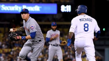 LOS ANGELES, CA - SEPTEMBER 04: Wilmer Flores #4 of the New York Mets fields a ground ball in front of Manny Machado #8 of the Los Angeles Dodgers leading to an out of Matt Kemp #27 to end the third inning at Dodger Stadium on September 4, 2018 in Los Angeles, California. (Photo by Harry How/Getty Images)