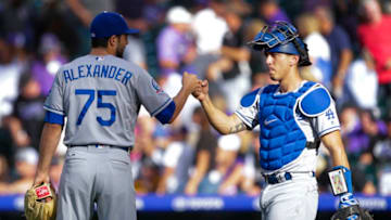 DENVER, CO - SEPTEMBER 09: Scott Alexander #75 of the Los Angeles Dodgers bumps fists with Austin Barnes #15 of the Los Angeles Dodgers after Alexander recorded the save against the Colorado Rockies at Coors Field on September 9, 2018 in Denver, Colorado. Los Angeles Dodgers beat Colorado Rockies 9-6. (Photo by Joe Mahoney/Getty Images)