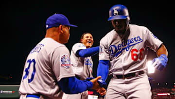 ST. LOUIS, MO - SEPTEMBER 14: Yasiel Puig #66 of the Los Angeles Dodgers is congratulated by Manny Machado #8 of the Los Angeles Dodgers after hitting home run against the St. Louis Cardinals in the second inning at Busch Stadium on September 14, 2018 in St. Louis, Missouri. (Photo by Dilip Vishwanat/Getty Images)