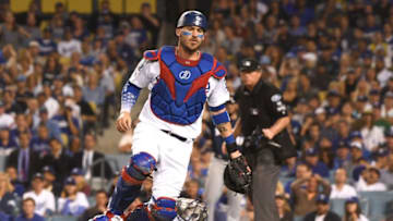 LOS ANGELES, CA - OCTOBER 15: Yasmani Grandal #9 of the Los Angeles Dodgers chases a wild pitch that allowed Travis Shaw #21 of the Milwaukee Brewers (not pictured) to score in the sixth inning in Game Three of the National League Championship Series at Dodger Stadium on October 15, 2018 in Los Angeles, California. (Photo by Harry How/Getty Images)
