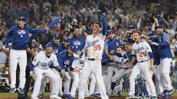LOS ANGELES, CA - OCTOBER 26: The Los Angeles Dodgers await to congratulate Max Muncy #13 at home plate after his eighteenth inning walk-off home run to defeat the the Boston Red Sox 3-2 in Game Three of the 2018 World Series at Dodger Stadium on October 26, 2018 in Los Angeles, California. (Photo by Harry How/Getty Images)