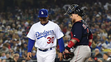 LOS ANGELES, CA - OCTOBER 27: Catcher Christian Vazquez #7 of the Boston Red Sox looks on as manager Dave Roberts #30 of the Los Angeles Dodgers walks by during the fourth inning of Game Four of the 2018 World Series at Dodger Stadium on October 27, 2018 in Los Angeles, California. (Photo by Harry How/Getty Images)