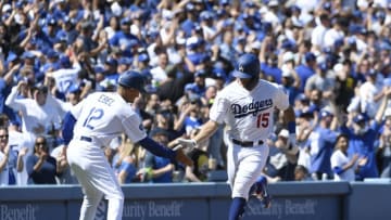 LOS ANGELES, CA - MARCH 28: Austin Barnes #15 of the Los Angeles Dodgers is congratulated by third base coach Dino Ebel #12 of the Los Angeles Dodgers after hitting a one run home run against Arizona Diamondbacks during the fourth inning on Opening Day at Dodger Stadium on March 28, 2019 in Los Angeles, California. (Photo by Kevork Djansezian/Getty Images)