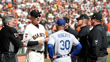 Bruce Bochy #15 of the San Francisco Giants talks to manager Dave Roberts #30 of the Los Angeles Dodgers (Photo by Lachlan Cunningham/Getty Images)