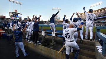LOS ANGELES, CALIFORNIA - OCTOBER 09: The Los Angeles Dodgers dug out celebrate after Max Muncy #13 hit a two run home run in the first inning of game five of the National League Division Series against the Washington Nationals at Dodger Stadium on October 09, 2019 in Los Angeles, California. (Photo by Harry How/Getty Images)