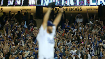 LOS ANGELES, CA - JUNE 18: Pitcher Clayton Kershaw #22 of the Los Angeles Dodgers reacts (foreground) after pitching a no-hitter against the Colorado Rockies as fans jubilate in the background after the MLB game at Dodger Stadium on June 18, 2014 in Los Angeles, California. The Dodgers defeated the Rockies 8-0. (Photo by Victor Decolongon/Getty Images)