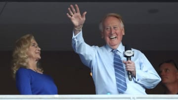 LOS ANGELES, CA - OCTOBER 20: Los Angeles Dodgers broadcaster Vin Scully waves to the crowd alongside his wife Sandra Hunt before the Dodgers take on the Chicago Cubs in game five of the National League Division Series at Dodger Stadium on October 20, 2016 in Los Angeles, California. (Photo by Sean M. Haffey/Getty Images)