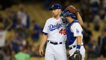 LOS ANGELES, CA - SEPTEMBER 26: Brock Stewart #48 hugs Yasmani Grandal #9 of the Los Angeles Dodgers after defeating the San Diego Padres 9-2 in a game at Dodger Stadium on September 26, 2017 in Los Angeles, California. (Photo by Sean M. Haffey/Getty Images)