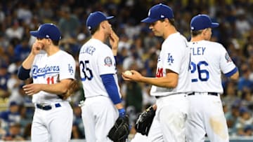 LOS ANGELES, CA - APRIL 14: Logan Forsythe #11, Cody Bellinger #35, Corey Seager #5 and Chase Utley #26 wait with starting pitcher Rich Hill #44 of the Los Angeles Dodgers for a review of a call on a three run home run by Deven Marrero #10 of the Arizona Diamondbacks in the fourth inning of the game at Dodger Stadium on April 14, 2018 in Los Angeles, California. (Photo by Jayne Kamin-Oncea/Getty Images)