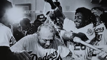 LOS ANGELES, CA - OCTOBER 1981: Pedro Guerrero #28 pours champagne on Manager Tommy Lasorda #2 of the Los Angeles Dodgers after defeating the Houston Astros in the divisional playoffs at Dodger Stadium, Los Angeles, California. (Photo by Jayne Kamin-Oncea/Getty Images)