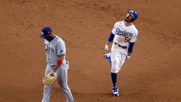 ARLINGTON, TEXAS - OCTOBER 27: Mookie Betts #50 of the Los Angeles Dodgers celebrates as he rounds the bases after hitting a solo home run as Yandy Diaz #2 of the Tampa Bay Rays looks on during the eighth inning in Game Six of the 2020 MLB World Series at Globe Life Field on October 27, 2020 in Arlington, Texas. (Photo by Sean M. Haffey/Getty Images)