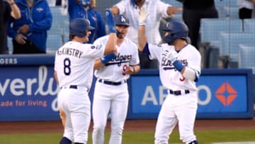 LOS ANGELES, CALIFORNIA - APRIL 10: Chris Taylor #3 of the Los Angeles Dodgers celebrates his three run homerun with Zach McKinstry #8 and Gavin Lux #9, to take a 5-1 lead over the Washington Nationals, during the second inning at Dodger Stadium on April 10, 2021 in Los Angeles, California. (Photo by Harry How/Getty Images)