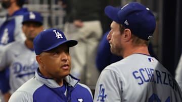 ATLANTA, GEORGIA - OCTOBER 17: Manager Dave Roberts talks to Max Scherzer #31 of the Los Angeles Dodgers after he took him out of the game against the Atlanta Braves in the fifth inning of Game Two of the National League Championship Series at Truist Park on October 17, 2021 in Atlanta, Georgia. (Photo by Kevin C. Cox/Getty Images)