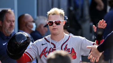 LOS ANGELES, CALIFORNIA - OCTOBER 19: Joc Pederson #22 of the Atlanta Braves is congratulated by teammates in the dugout after scoring during the 4th inning of Game 3 of the National League Championship Series against Los Angeles Dodgers at Dodger Stadium on October 19, 2021 in Los Angeles, California. (Photo by Harry How/Getty Images)