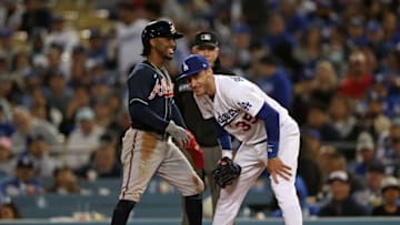 LOS ANGELES, CALIFORNIA - OCTOBER 20: Ozzie Albies #1 of the Atlanta Braves speaks with Cody Bellinger #35 of the Los Angeles Dodgers on first base during the fourth inning of Game Four of the National League Championship Series at Dodger Stadium on October 20, 2021 in Los Angeles, California. (Photo by Ronald Martinez/Getty Images)