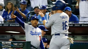 PHOENIX, ARIZONA - SEPTEMBER 24: Manager Dave Roberts #30 of the Los Angeles Dodgers points to first base as Will Smith #16 of the Dodgers scores against the Arizona Diamondbacks on a RBI single by Justin Turner of the Dodgers during the second inning of the MLB game at Chase Field on September 24, 2021 in Phoenix, Arizona. (Photo by Ralph Freso/Getty Images)